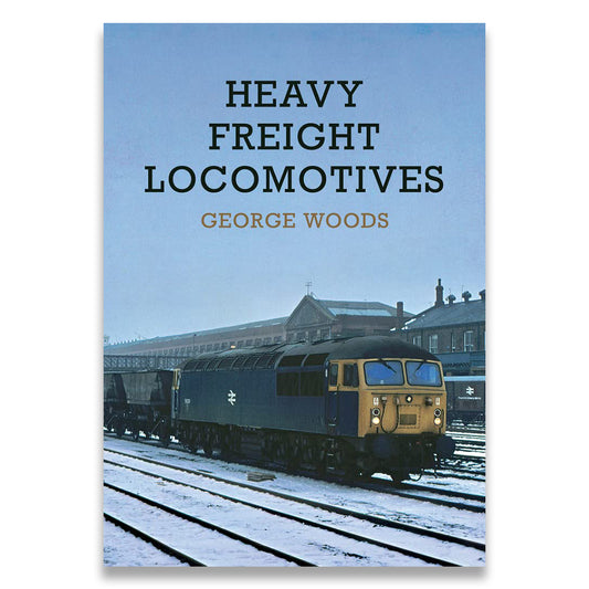Book cover of 'Heavy Freight Locomotives' by George Woods with a train on tracks.
