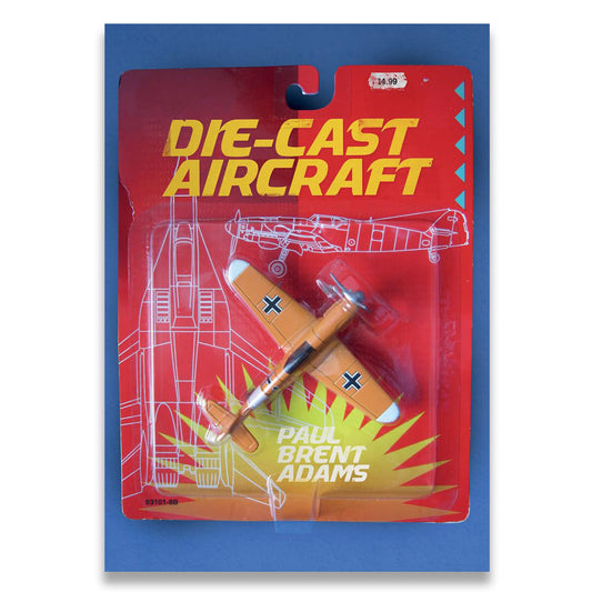 Die-cast aircraft model in packaging with 'Paul Brent Adams' branding