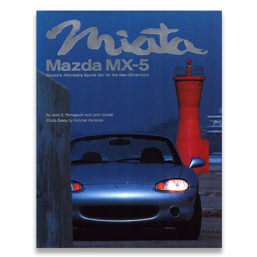 Book cover of 'Mazda MX-5' with a blue car and red lighthouse in the background