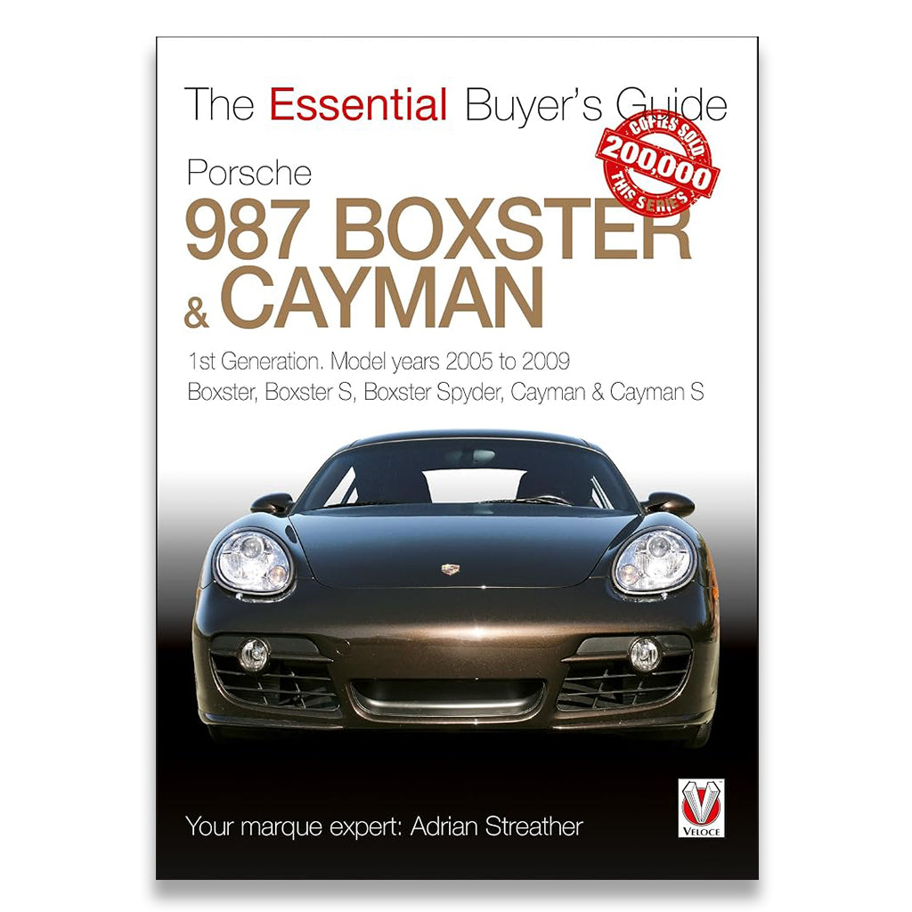 Book cover for 'The Essential Buyer's Guide Porsche 987 Boxster & Cayman' by Adrian Streather, featuring a front view of a dark Porsche car on a white-to-black gradient background with a red '200,000+ reviews sold' badge.