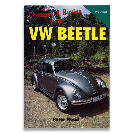 Book titled 'Chasing & Buying that VW Beetle' on a wooden surface